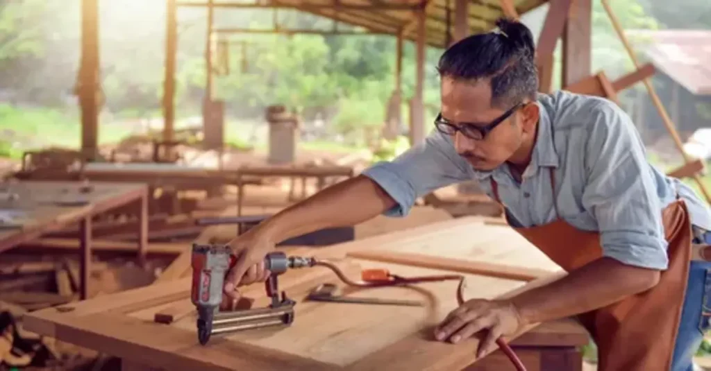 Professional carpenters working on the wooden framework of a house under construction, using tools and blueprints to guide the building process.
