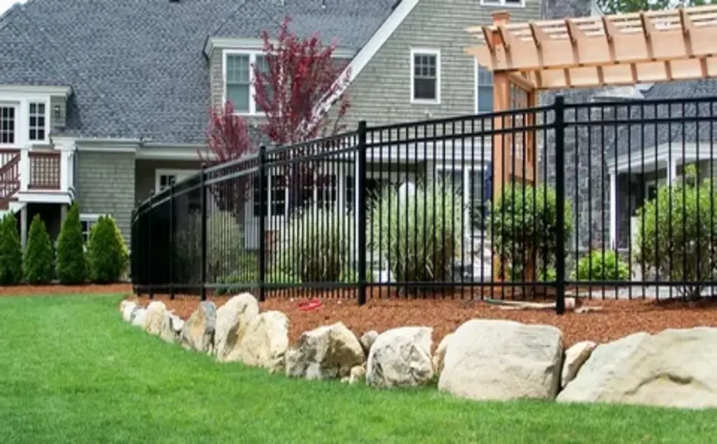 Backyard enclosed with a wooden privacy fence installed through professional fencing services.