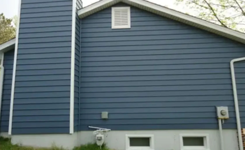 Well-maintained home exterior featuring clean vinyl siding, representing quality siding and maintenance services