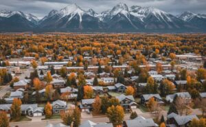 Montana neighborhood with homes surrounded by golden fall trees and early frost, showing well-maintained siding and roofs ready for winter.