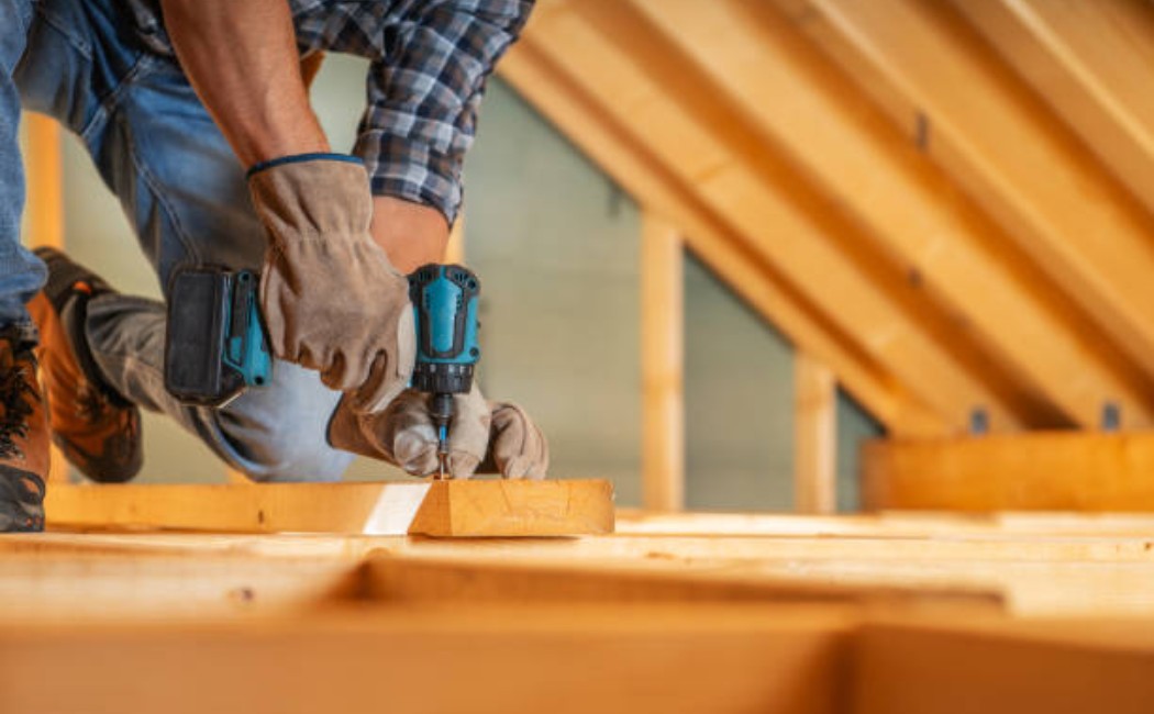 Expert carpenter securing wooden structures with power tools